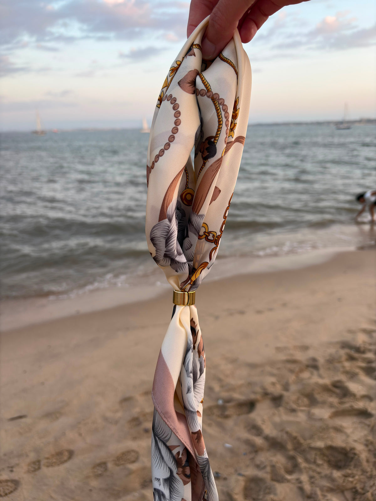 Chaîne Scarf held at the beach