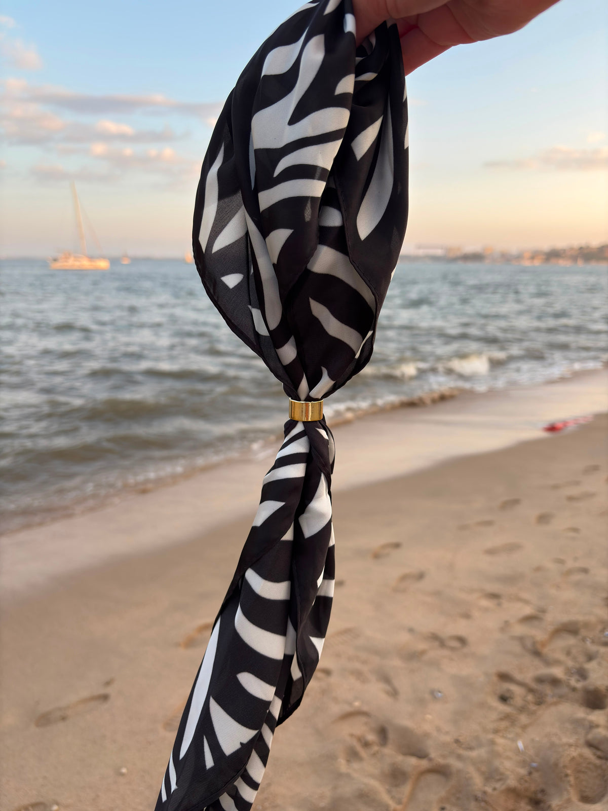 Nuit Scarf held at the beach in evening light