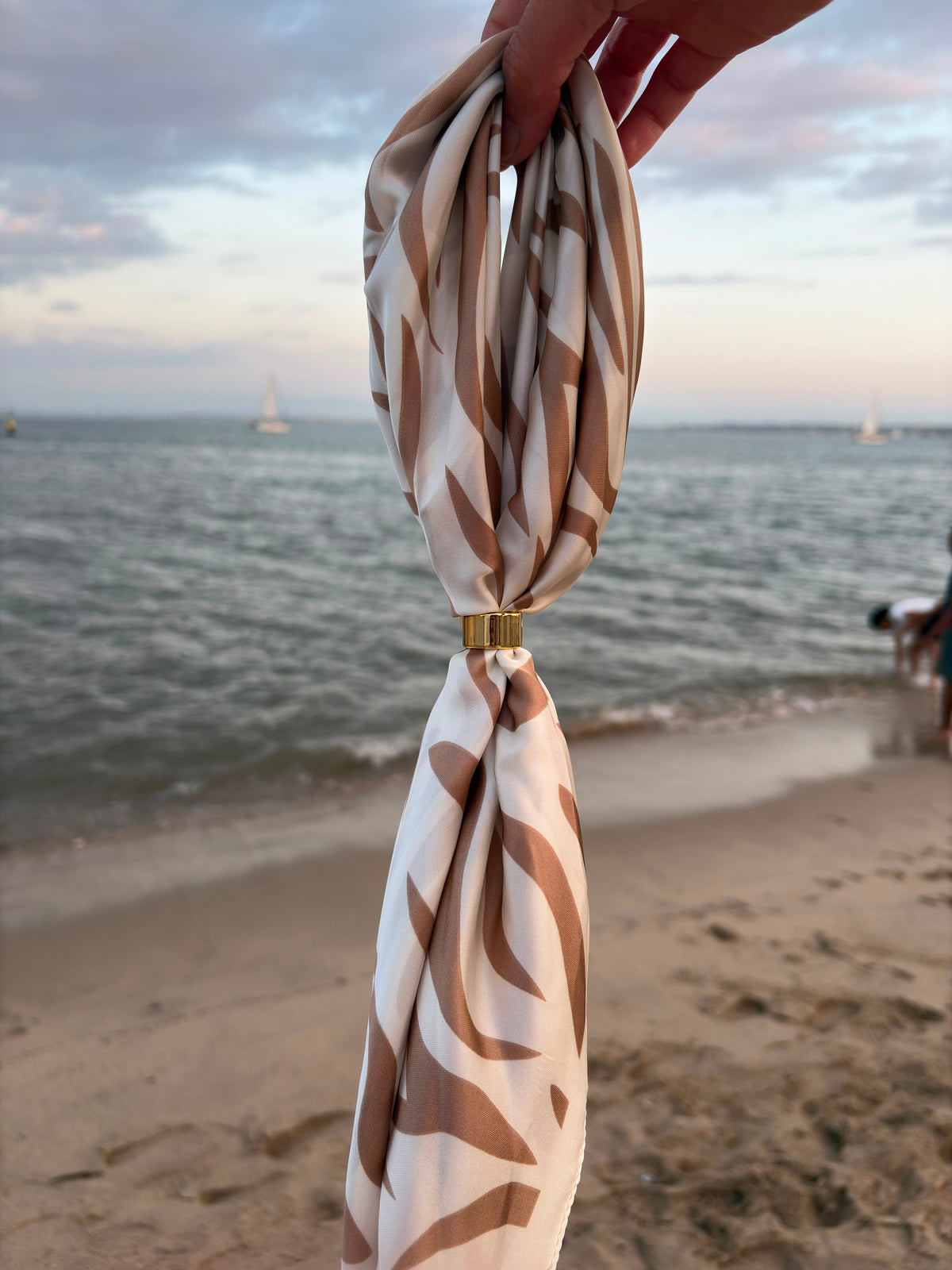 Feuille Scarf held at the beach