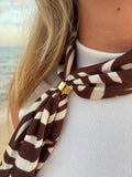 Marron Scarf worn as neckerchief at the beach