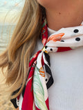 Cerise Scarf worn as neckerchief at the beach